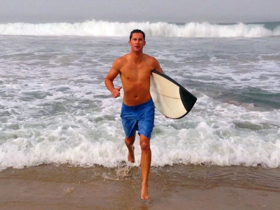 1 Kalon McMahon running on beach with surfboard
