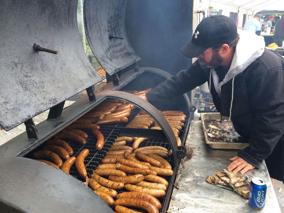 10 Q for a Cause November 2013 cooking sausage on a barbecue pit