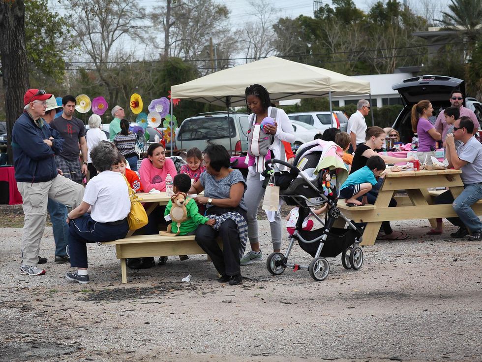 12 Guests enjoying lunch at the picnic tables at Evelyn's Park's Pop-Up event February 2014