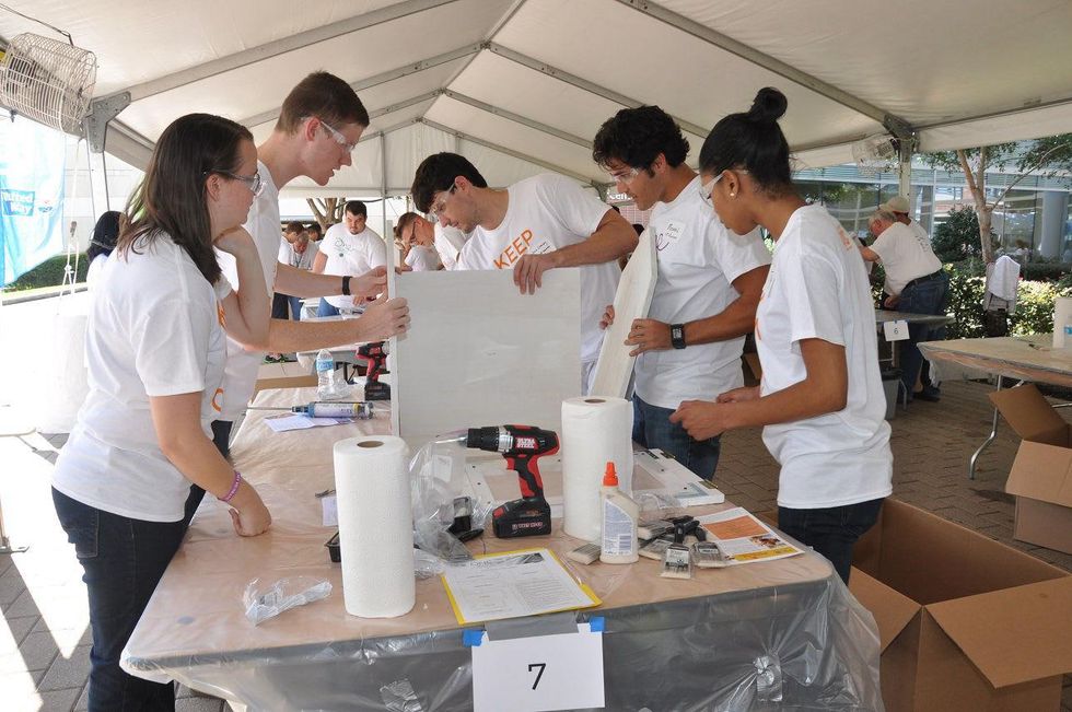 14 A group of LINC members get to work by building the tiny library at young professionals build Tiny Libraries September 2014