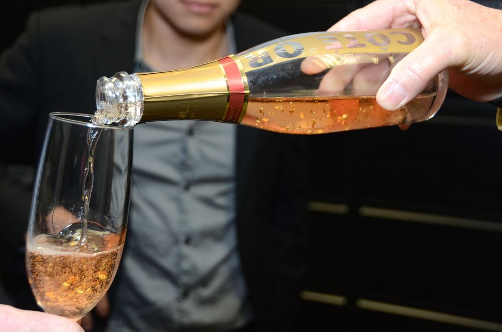 164 Pouring a glass of Bottle of Cote Or gold-flecked champagne at the Red Carpet Soiree November 2014