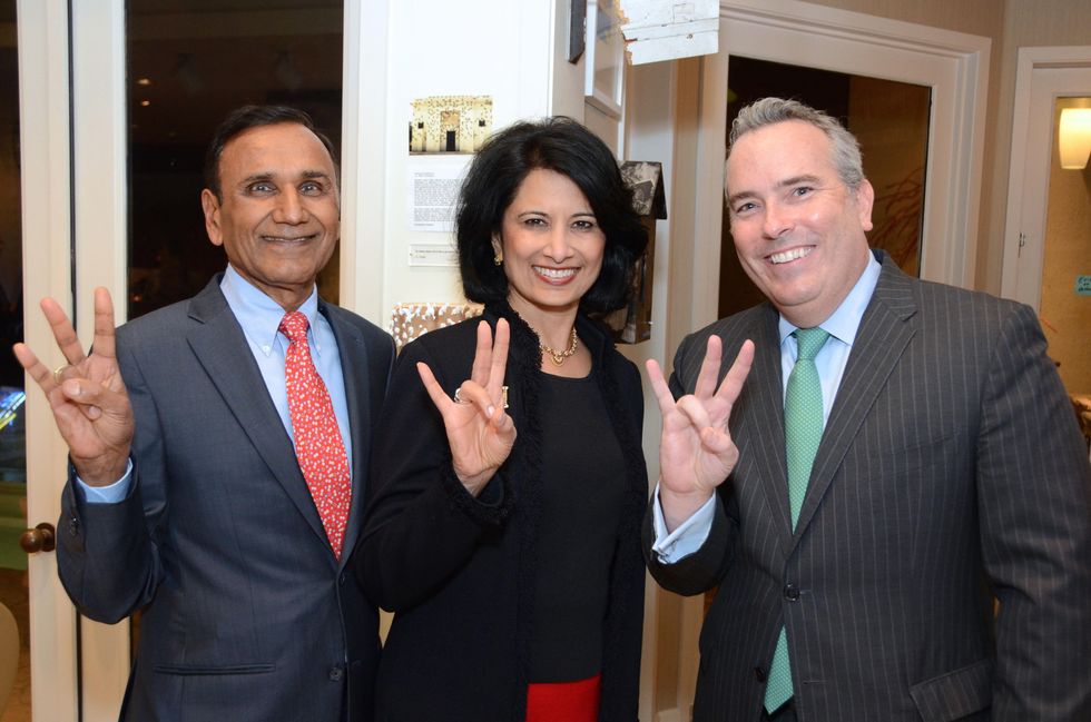 18 123 Drs. Suresh and Renu Khator, left, with Jason Fuller at the Rick Lowe Party December 2014