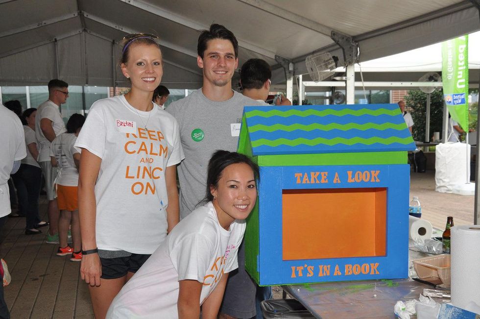 19 Britni Keith, from left, Aaron Pelletier and Diana Dao at young professionals build Tiny Libraries September 2014