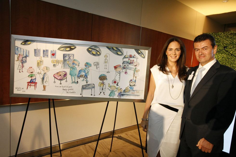 19 Karla and Jorge Goudet with painting by Mexico-based artist Luis Lara at the Texas Children's Hospital What's Up Doc dinner November 2014