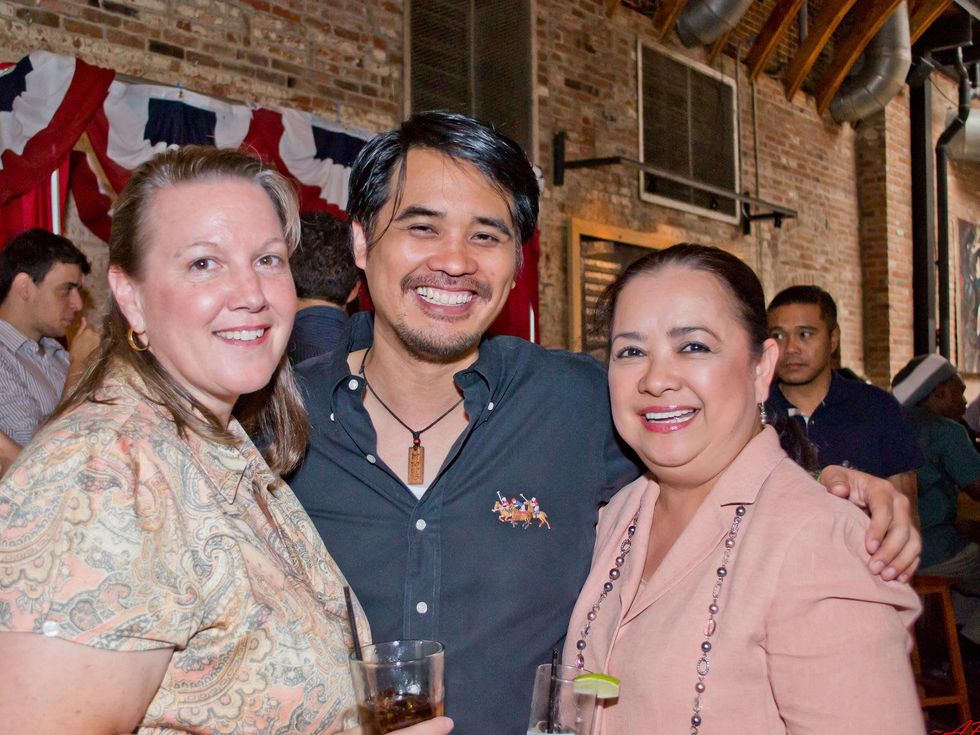 19 LeeAnne Nash, from left, Anthony Guevara and Tess Tuazon at the Young Professionals Grand Prix kick-off party June 2014