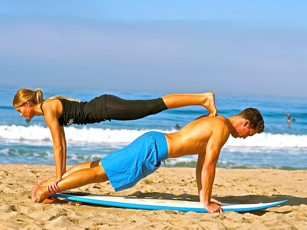 2 Kalon McMahon on beach with girl and surfboard