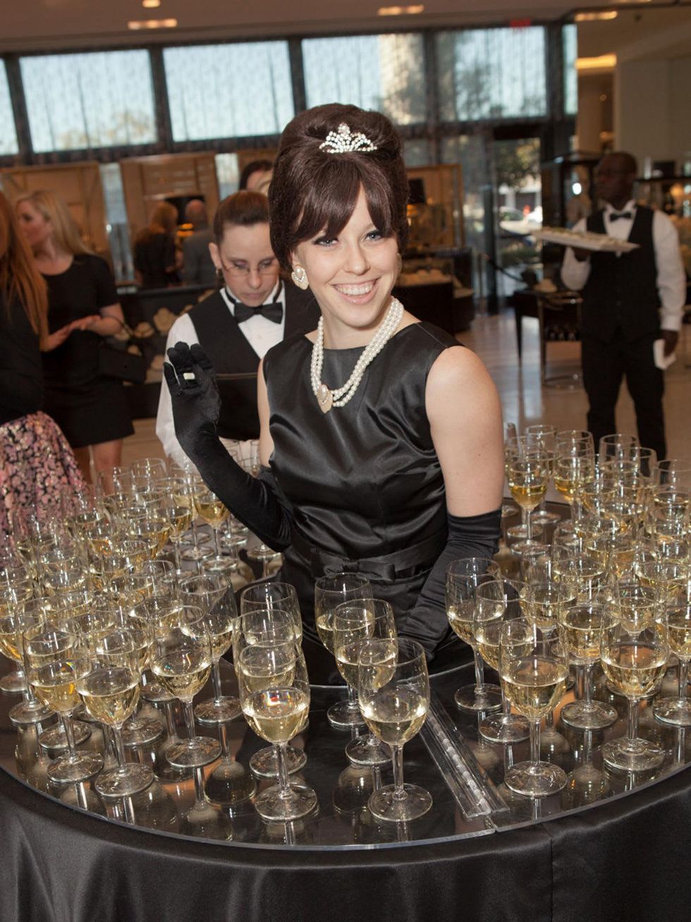 2. Model serving wine at the Little Black Dress designer kick-off party and fashion show March 2014