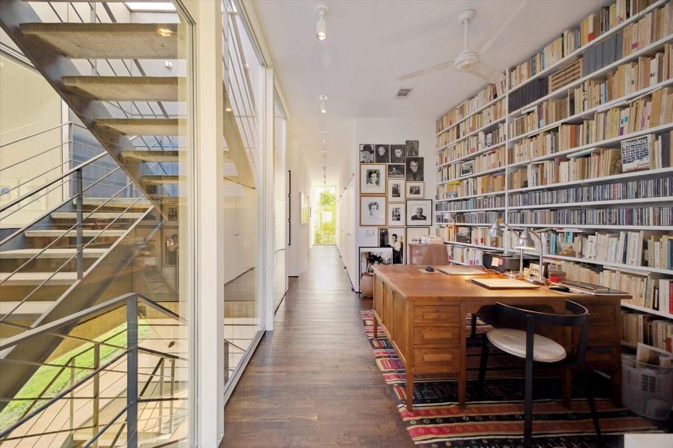 3308 St. Emanuel interior with metal stairs and a wall of built-in bookshelves