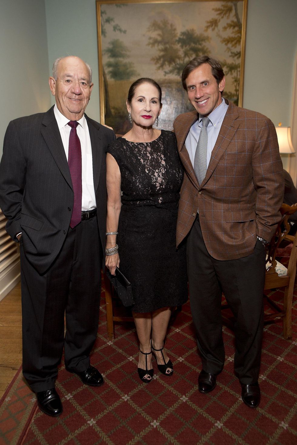 384 Rigo and Sally Flores, from left, with Greg Holloway at the Living Bank Gala October 2014