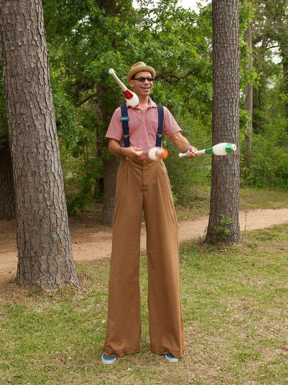 4, Texas Children's Ambassadors party April 2013 A man on stilts juggling