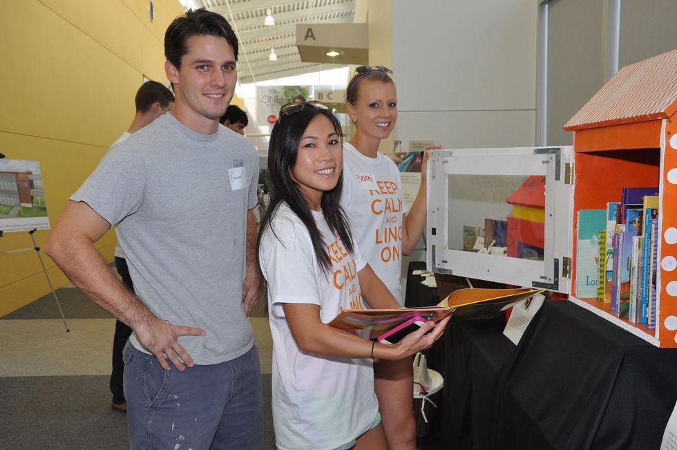 5 Aaron Pelletier, from left, Diana Dao and Britni Keth at young professionals build Tiny Libraries September 2014