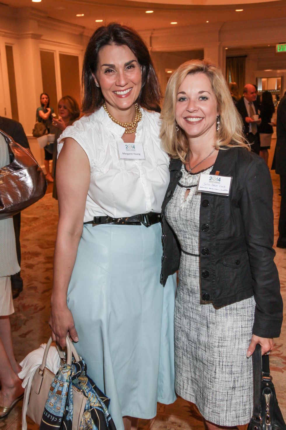 7776 Margaret Young, left, and Julie Baker Finck at the Mayor's Literacy Breakfast May 2014