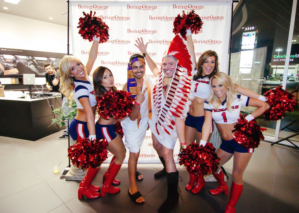 8 Event chairs Maneesh Singal, left, and Paul Pettie with Texans cheerleaders at the Bering Omega Toga Party July 2014