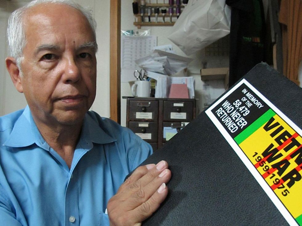 8 Katie July 2013 Jimmie's Reweaving & Alterations George Flores (owner of Jimmie\u2019s Reweaving & Alterations) with scrapbook