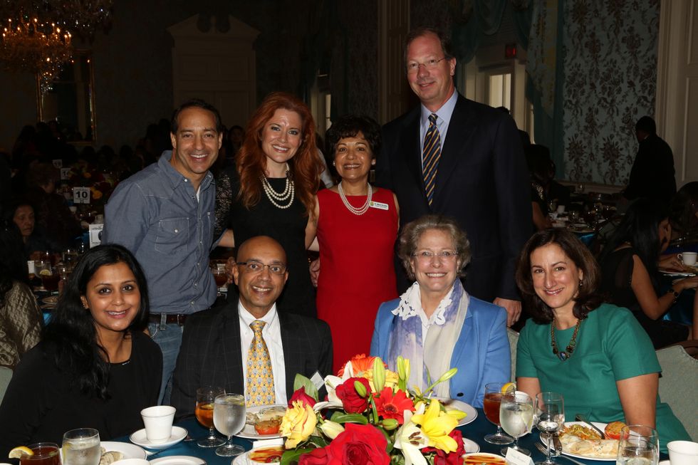 9. Vinita Gupta, from left, Vijay Goradia, Lillie Robertson and Nancy Thorington. Standing, from left, Lynt Graft, Ingrid Vanderveldt, Marie Goradia and Steve Thorington at the Chloe Dao luncheon for Pratham December 2014