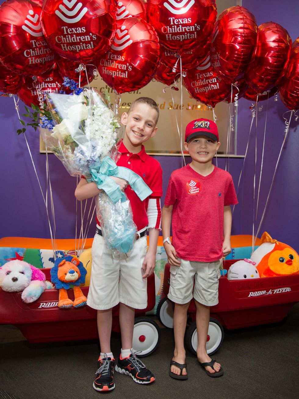 9590 Patrick DeClaire, left, and Caleb Cook at the Lester and Sue Smith Clinic dedication at Texas Children's Hospital May 2014