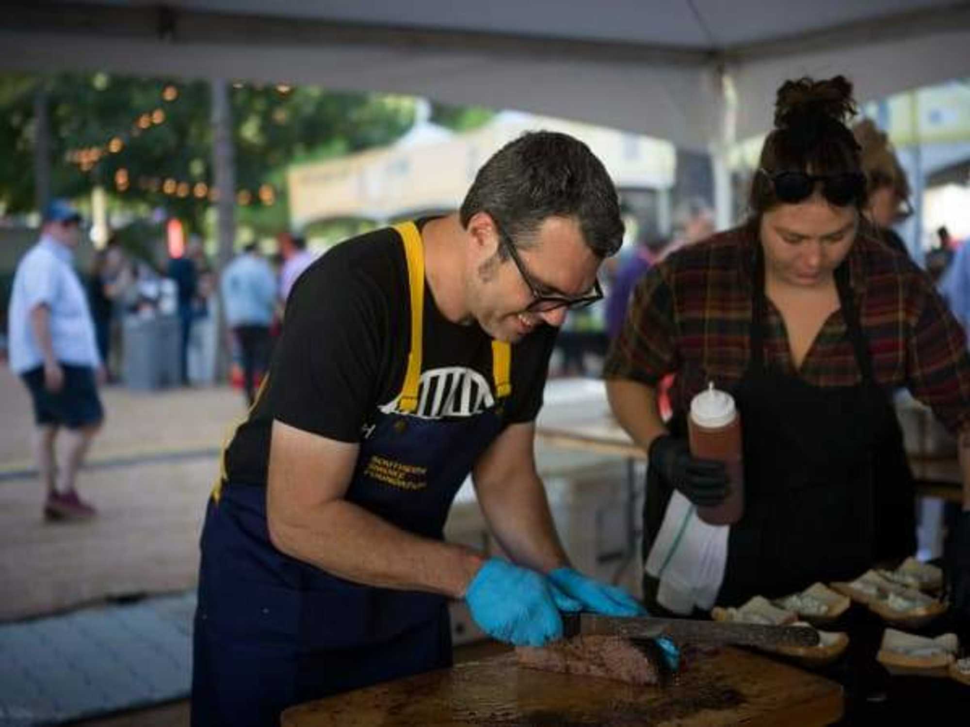 A chef cuts brisket at the 2023 Southern Smoke Foundation Festival.