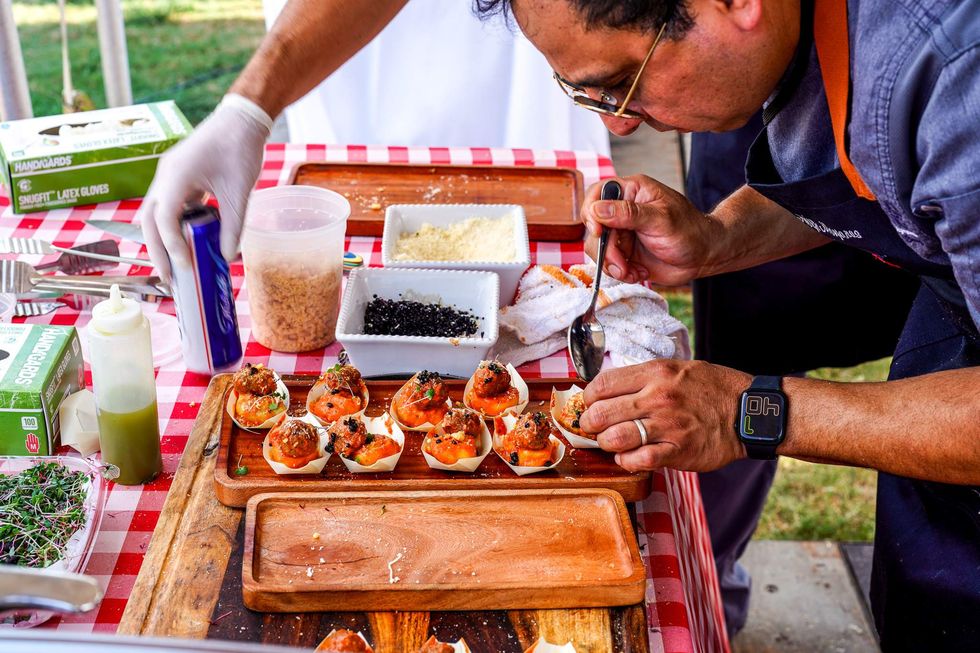 A chef puts finishing touches on a dish at the Chefs for Farmers event.