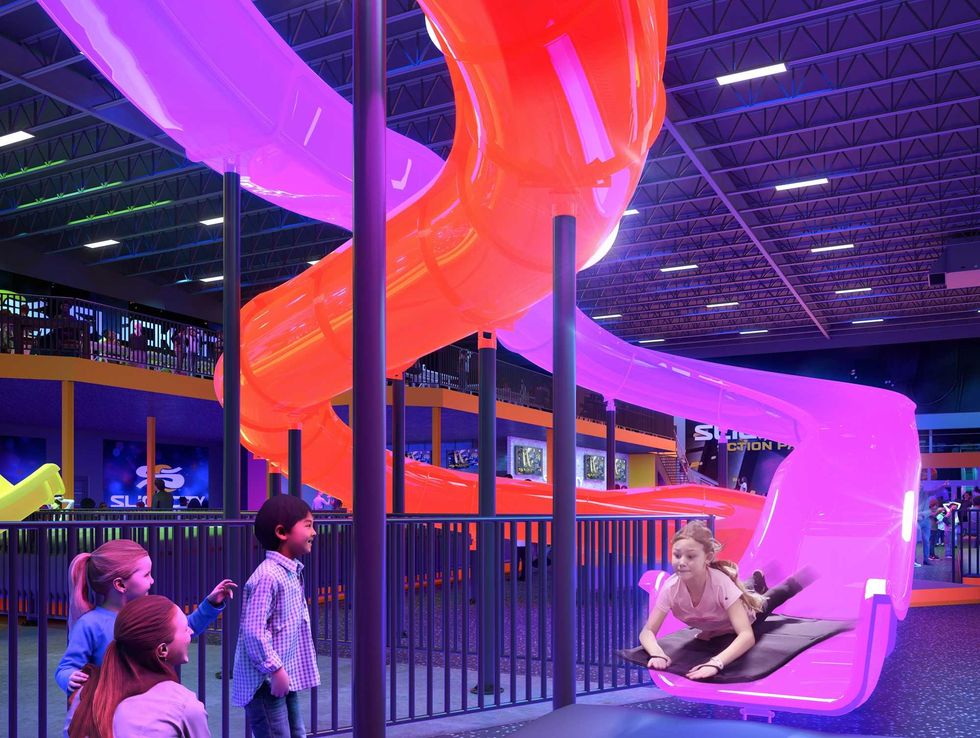 A child slides at Slick City