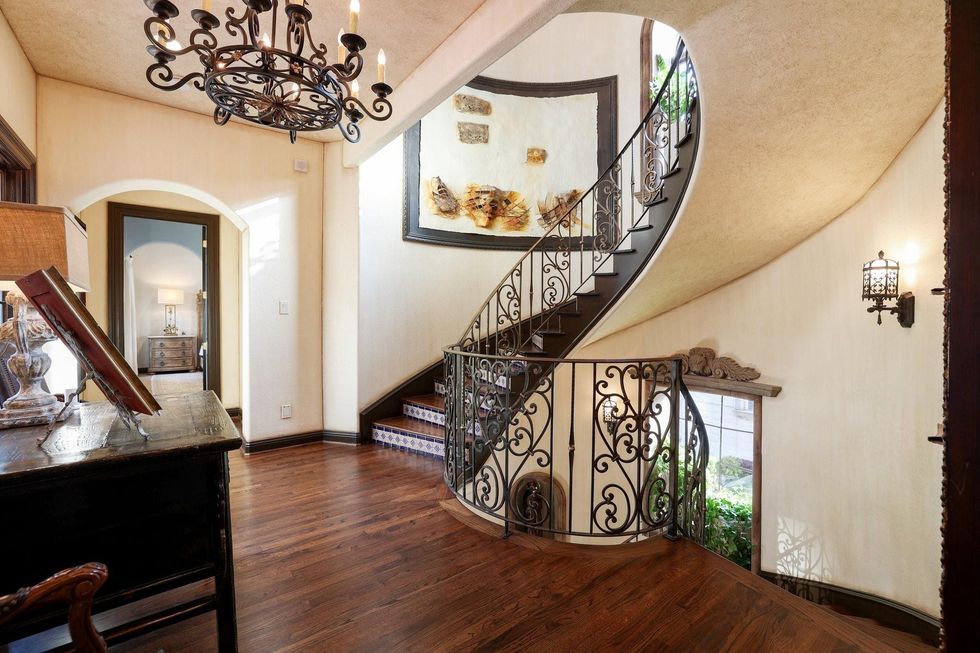 A curving staircase at 5007 Cedar Creek Drive