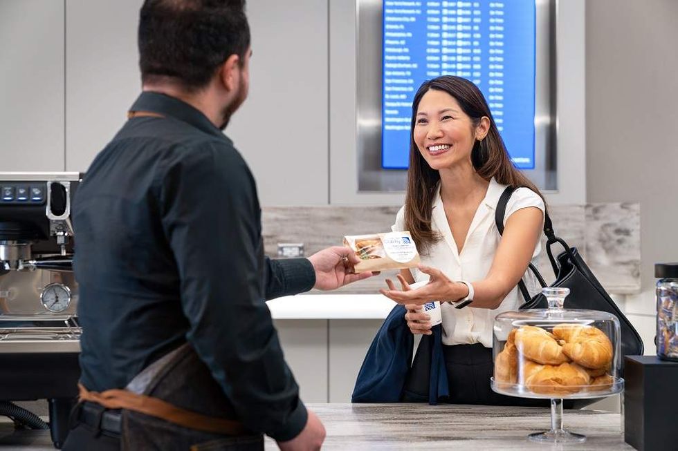 A customer gets a hot pastry at United Fly Club