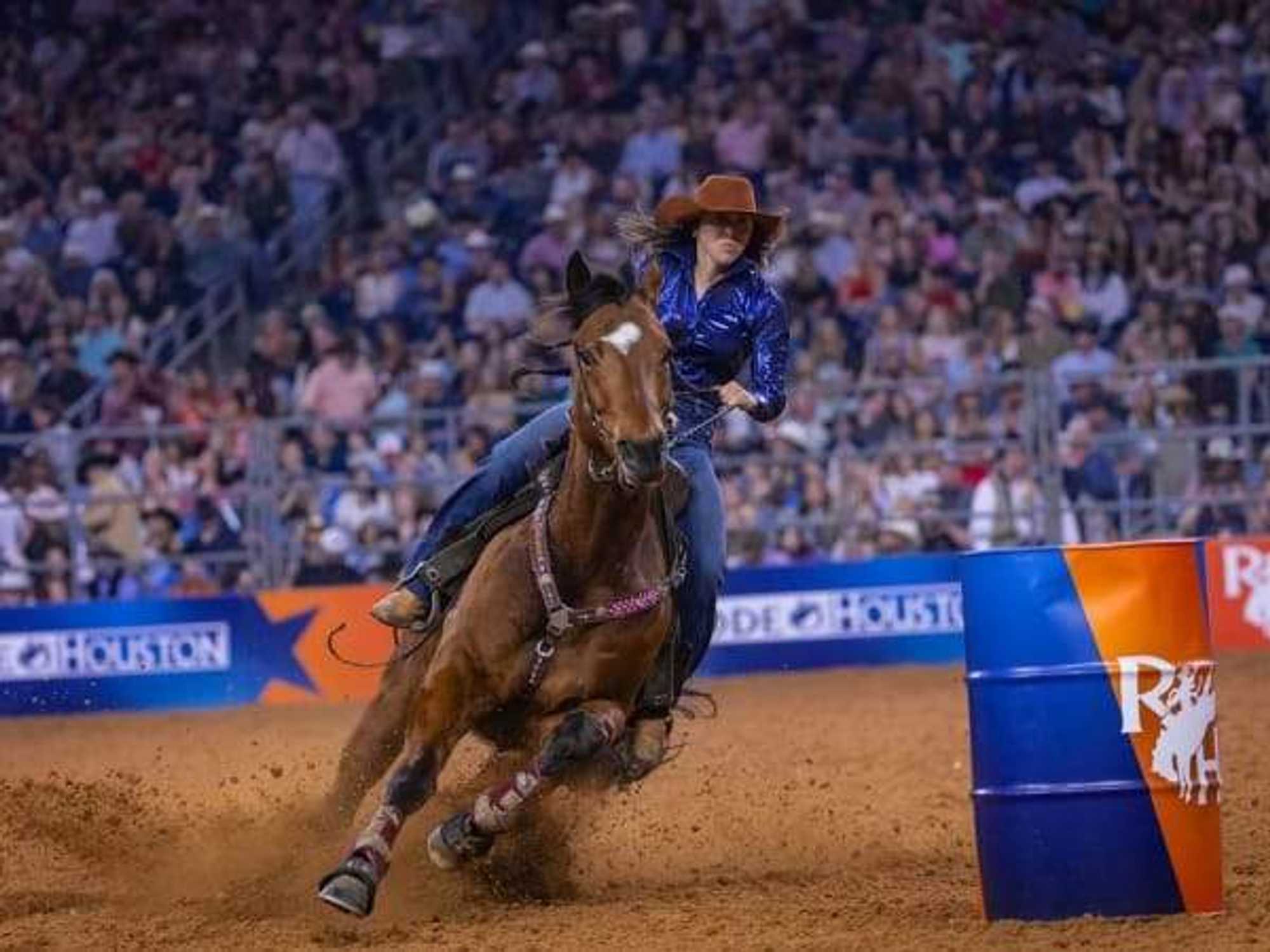 A female barrel rider performs at the 2025 Houston LIvestock Show and Rodeo.