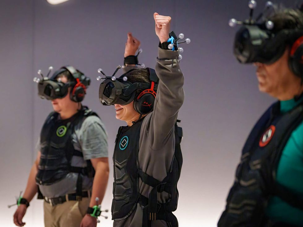 A group in VR goggles in a gaming room