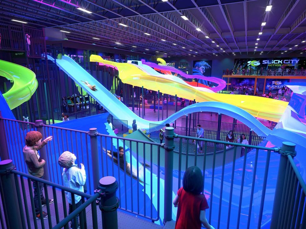 A group of children enjoy the sldies at Slick City