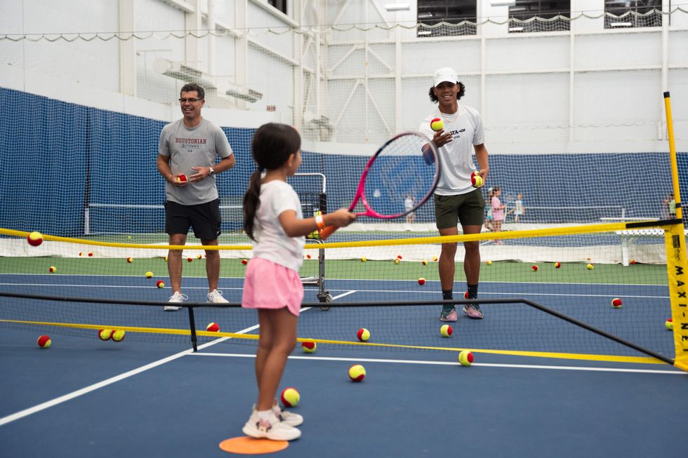 A little girl playing tennis