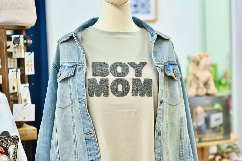A mannequin wearing a jean jacket and T that reads Boy Mom at ParkerJoe boutique