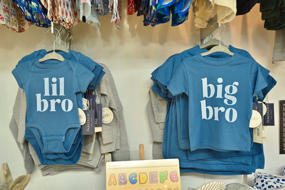 A onsie reading lil bro and a T-shirt reading big bro at ParkerJoe boutique