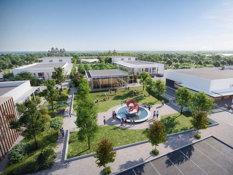 A quad full of people on a nice day in a housing development.