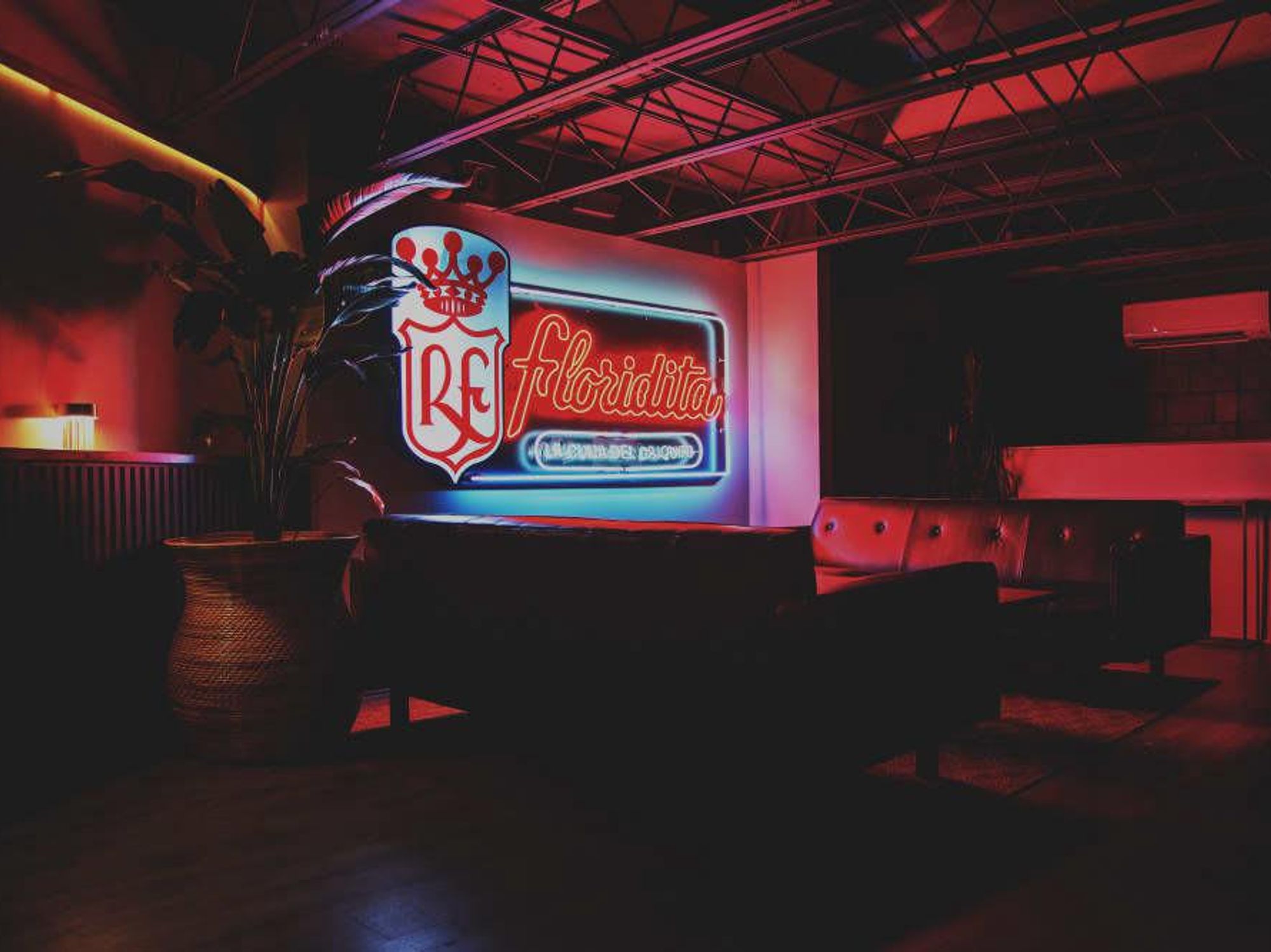 A replica neon sign illuminates the room.