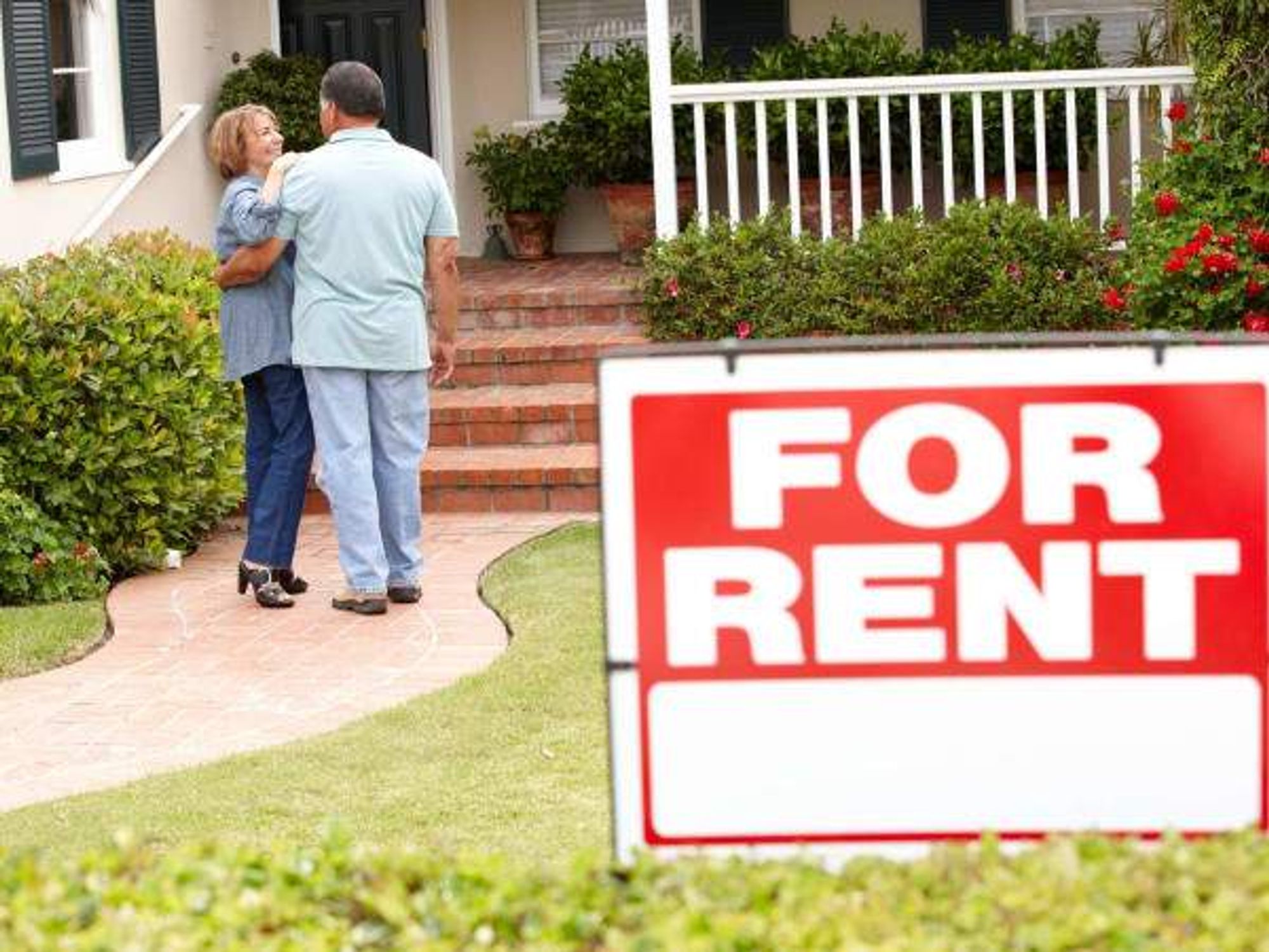 A senior couple inspecting a potential house rental
