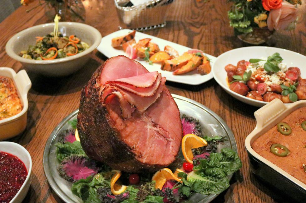 A spiral ham o a table with side dishes