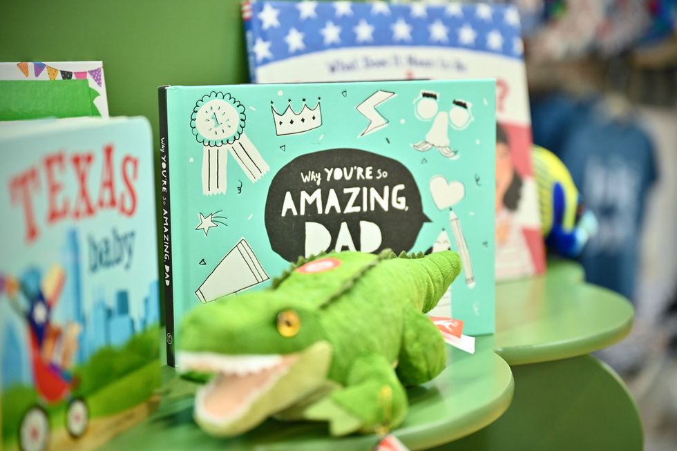 A stuffed alligator and a book in ParkerJoe boutique