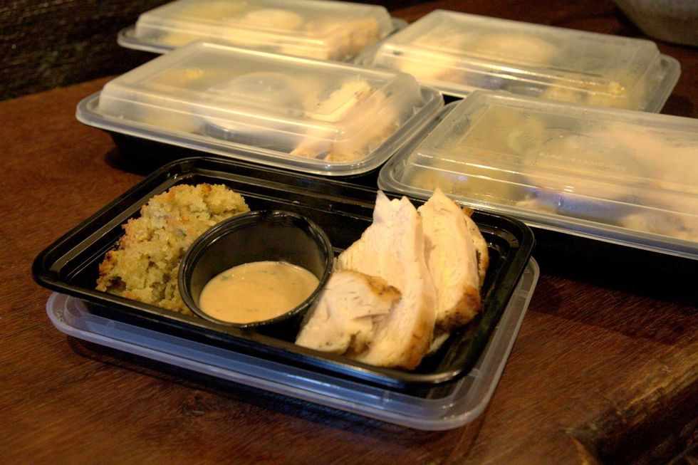 A to-go box with turkey, stuffing and gravy for one.