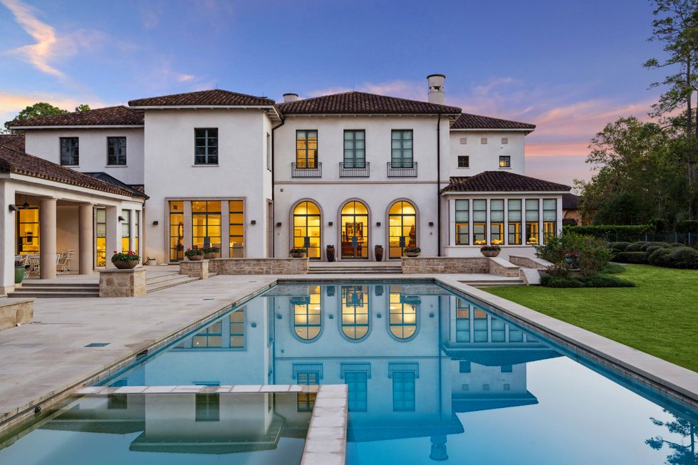 A view of the backyard of 119 Carnarvon Drive, showcasing the pool and spa