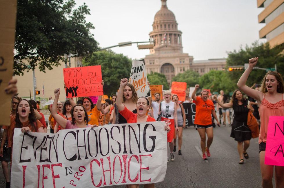 Abortion rally protestors march by Capitol