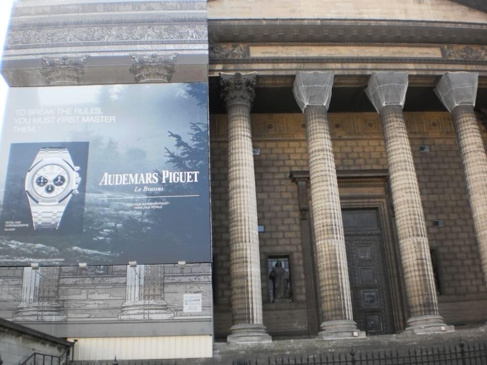 Ad for Audemars Piguet presents a contemporary counterpoint on the facade covering construction work at Place de la Madeleine in Paris
