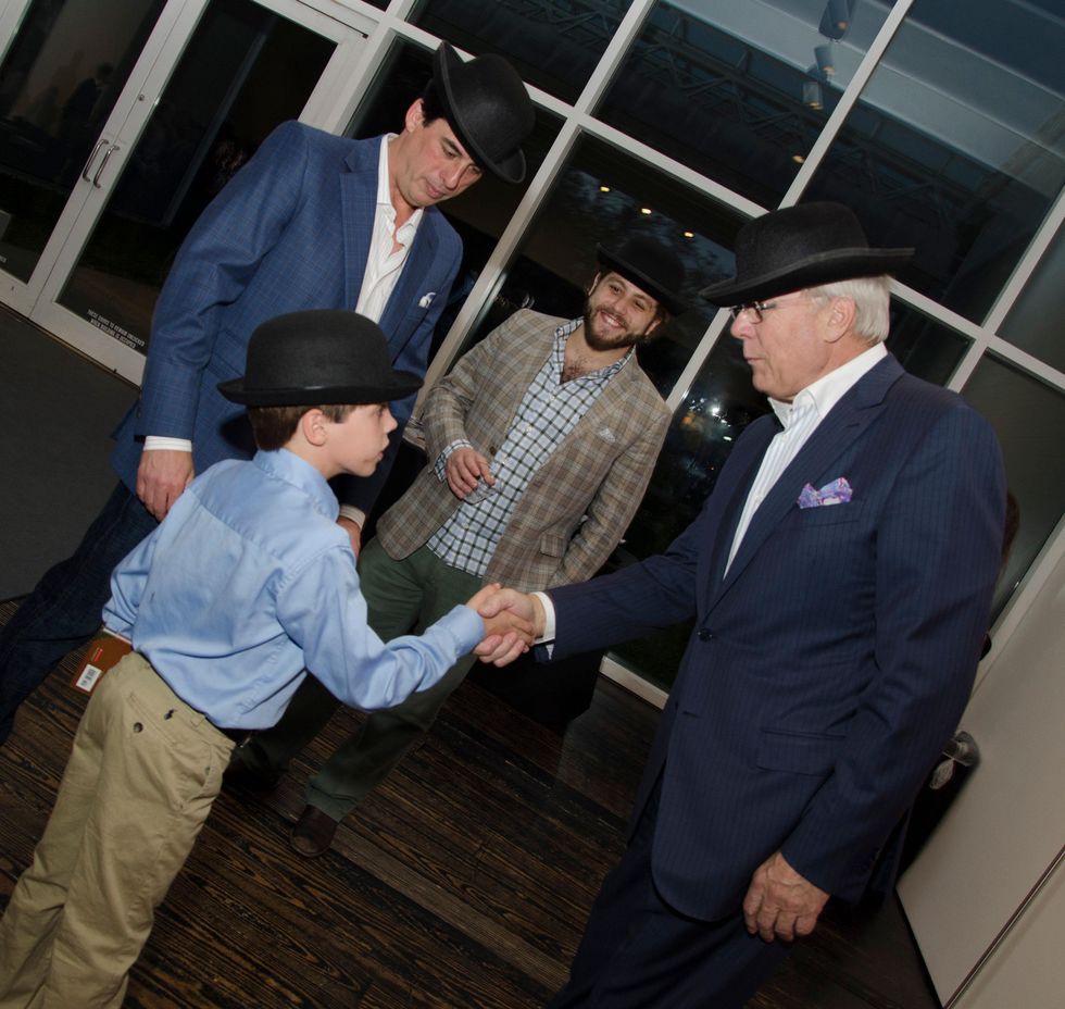 Alden Davenport shakes hands with Butch Layne at M Penner Magritte party