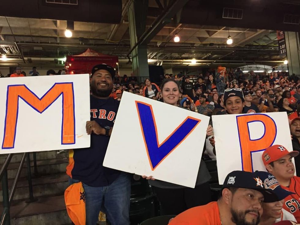 (Altuve) MVP sign held by Andrew Callis, Wendy Callis, Collin Callis hold an Altuve MVP sign at Minute Maid Park Game 7 World Series watch party