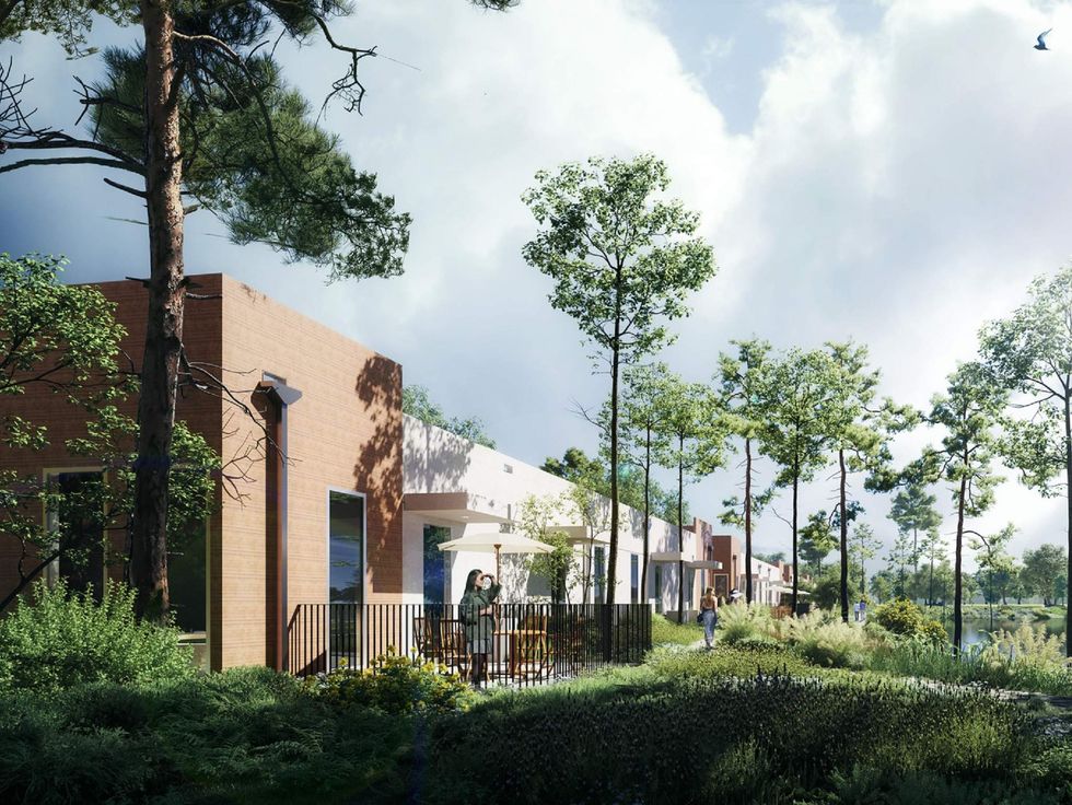 An outdoor porch in a new housing development overlooking a lake.