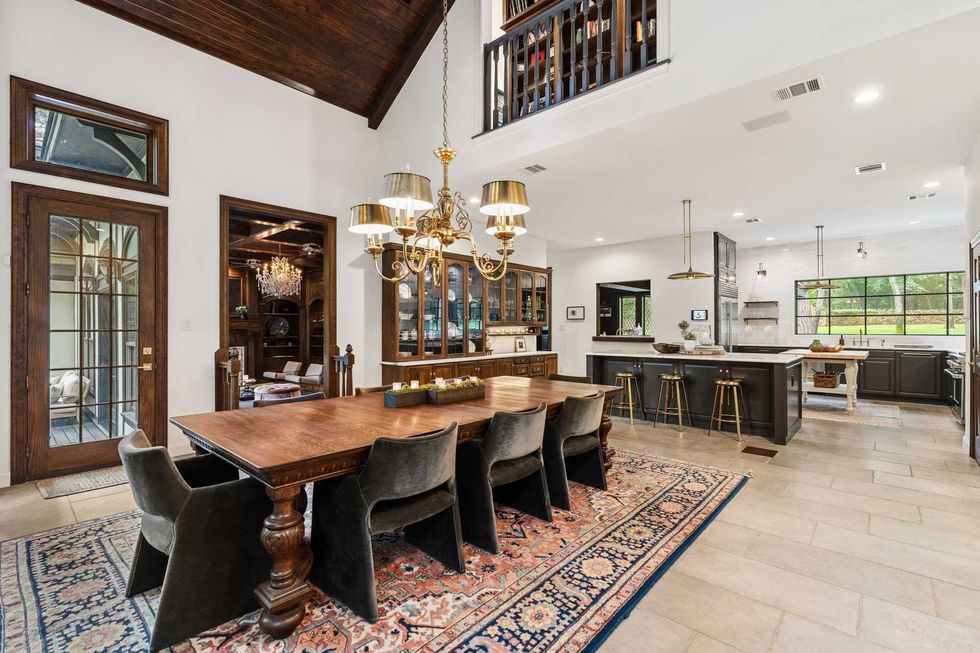 Another view of the dining room, looking back to the kitchen with bar stool seats along the island
