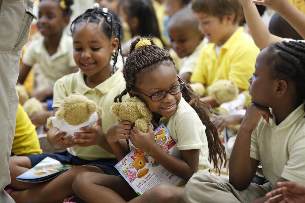 Atherton Elementary School students receive book and teddy bear from John Moore