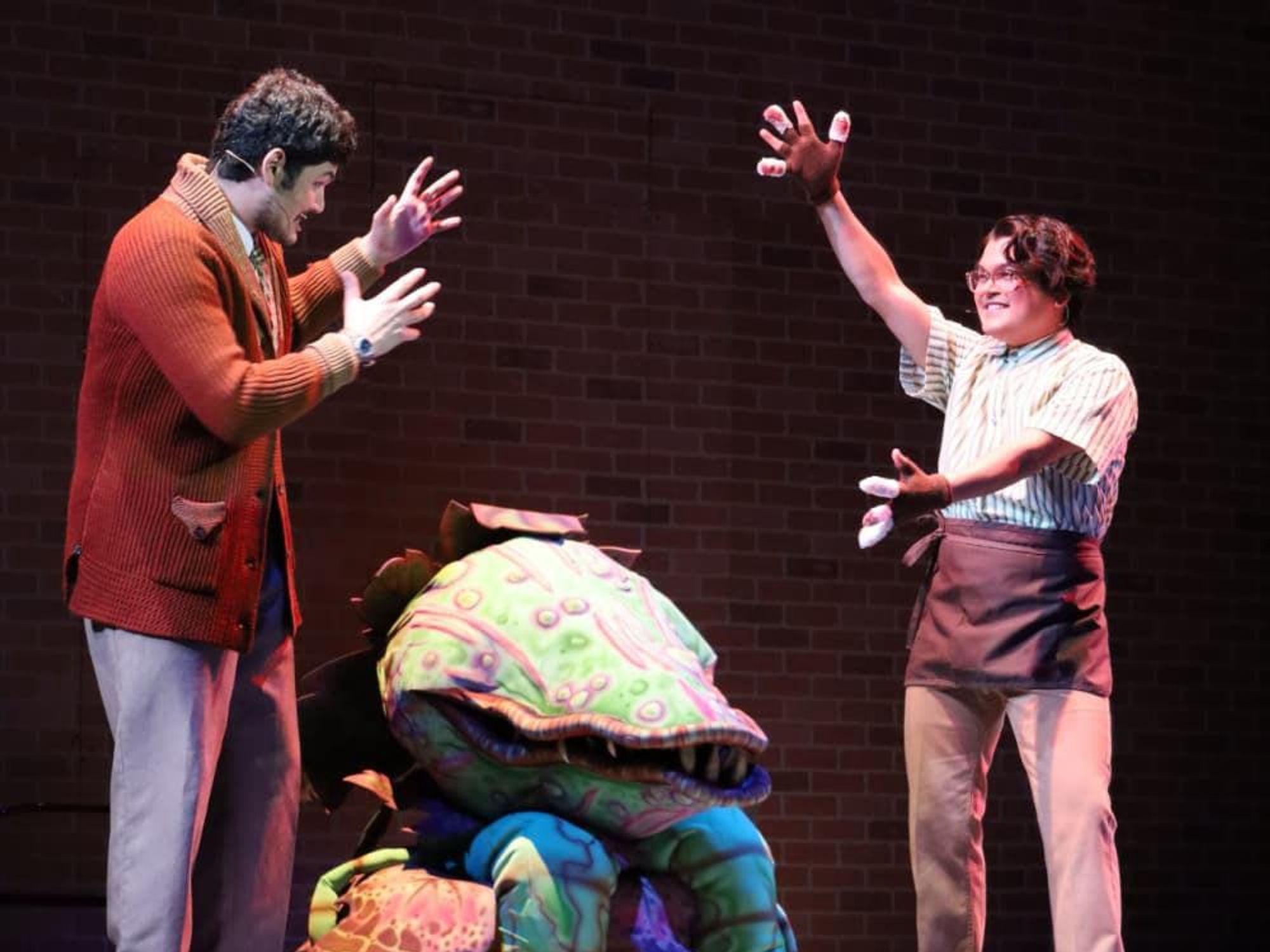 Audrey II (center) is Little Shop of Horrors' show-stealing, murderous plant.
