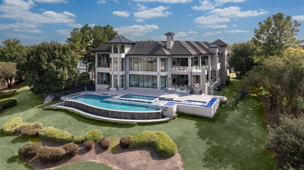 Backyard of 3102 Noble Lakes Lane showing a multilevel pool and spa