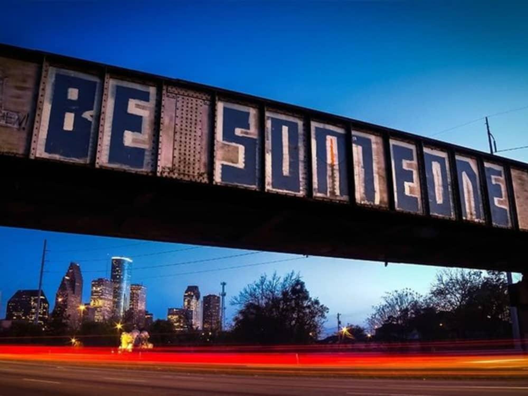 Be Someone graffiti sign