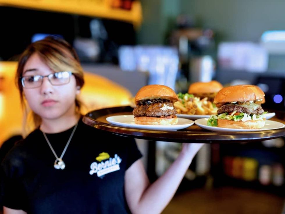 Bernie's Burger Bus Missouri City server with burgers