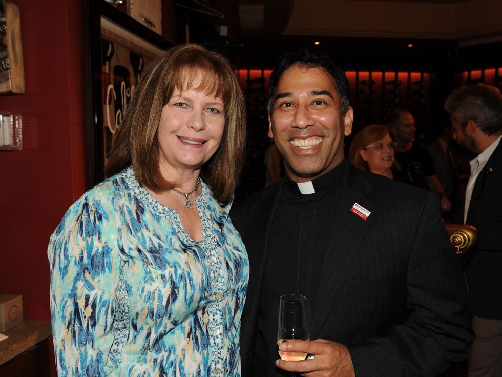 Beverly Cheek and Father Kevin Storey at the Michele Pozo jewelry show August 2014